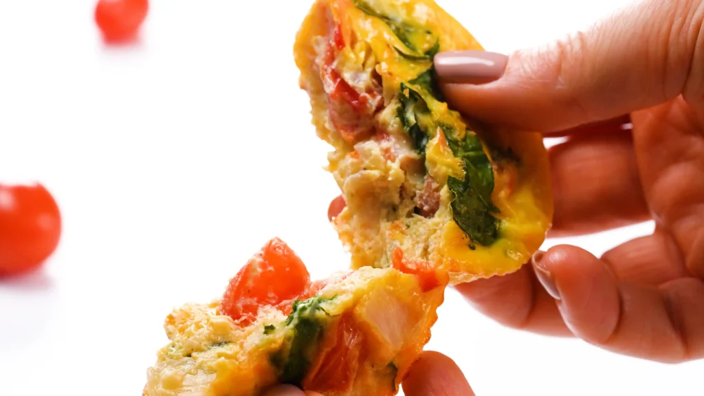 Egg Muffins with Spinach and Feta close up and pulled apart